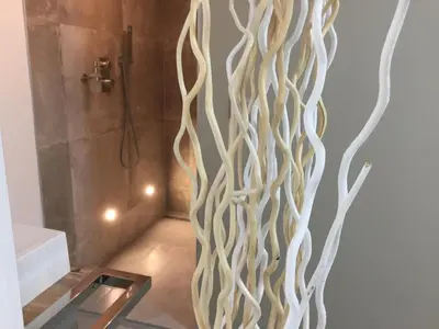 a bathroom with a shower with a wooden wall at LOFT SPA - Côté château. in Carcassonne