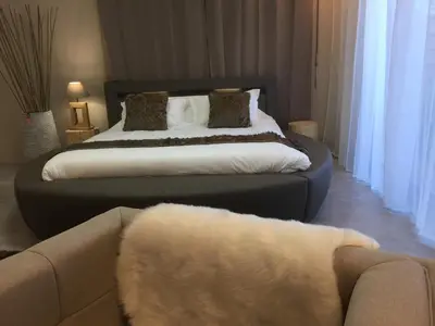 a bedroom with a large bed with a couch at LOFT SPA - Côté château. in Carcassonne