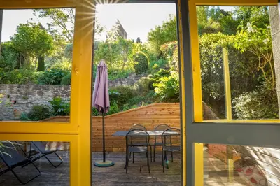 a view from a window of a patio with a table and chairs at Sous les courtines in Carcassonne