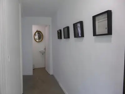 a hallway with four pictures on a wall at La Bouriotte Gîtes in Labastide-Rouairoux