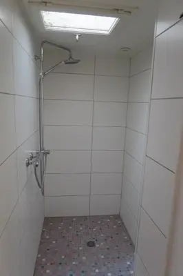 a bathroom with a shower with a glass door at Le Domaine de Fraissinet in Ouveillan