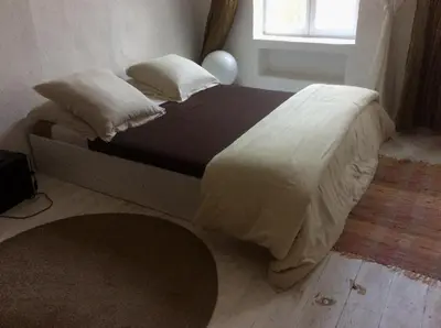 a bed with white sheets and pillows in a bedroom at La planque in Gruissan