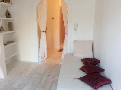 a room with a bed with three pillows on it at La planque in Gruissan