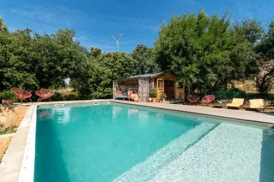 a swimming pool in front of a house at Gite Soyez in Vélieux