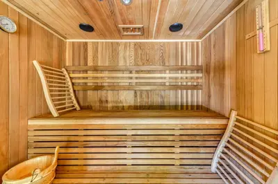 a sauna with wooden walls and wooden stairs at Gite Soyez in Vélieux