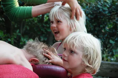 two little girls are playing with each other at Gite Soyez in Vélieux