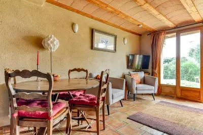 a dining room with a table and chairs at Gite Soyez in Vélieux