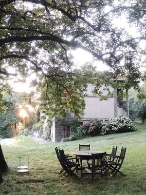 a picnic table and chairs under a tree at La Bouriotte Chambre d'hôtes Bouton D'Or in Labastide-Rouairoux