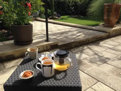 a table with two cups of coffee and two cups of tea at La Glycine Blanche in Pomas