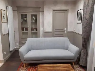 a living room with a couch and a window at La Glycine Blanche in Pomas