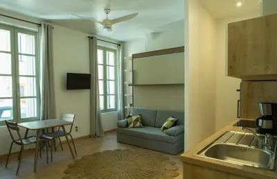 a living room with a couch and a table at La Maison des Vendangeurs sur Mer in Gruissan