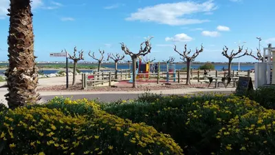 a park with trees and flowers on the beach at Studio Moderne - Plage du Grazel in Gruissan