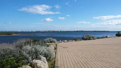 a pathway next to a body of water at Studio Moderne - Plage du Grazel in Gruissan