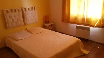 a small bedroom with a bed and a window at L'Ispanina in Thézan-des-Corbières