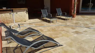two chairs sitting on a tile floor with a hose at L'Ispanina in Thézan-des-Corbières