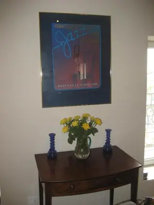 a vase of flowers on a table with two blue vases at Gites de Gabrielle in Capestang