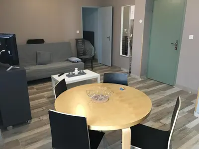 a living room with a wooden table and chairs at Appartements 
