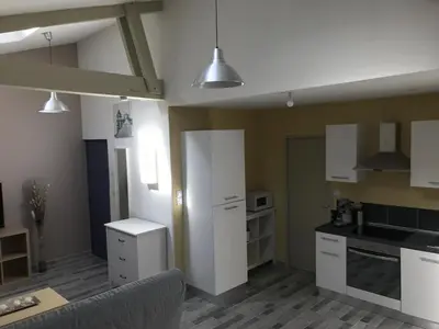 a kitchen with white cabinets and white appliances at Appartements 