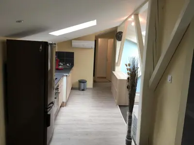 a hallway leading to a kitchen in a house at Appartements 