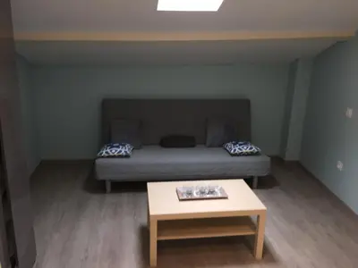 a small room with a bed and a table at Appartements 