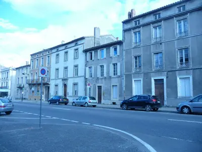 a street with cars parked in front of buildings at Appartement au coeur de Carcassonne in Carcassonne
