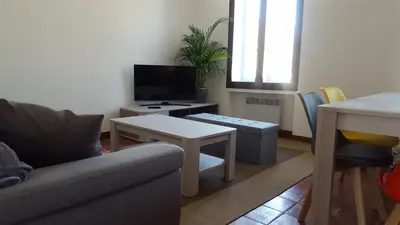 a living room with a couch and a table at Appartement au coeur de Carcassonne in Carcassonne