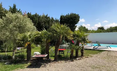 a park with palm trees and a swimming pool at Aux Belles Vacances - ADULTS ONLY in Caux-et-Sauzens