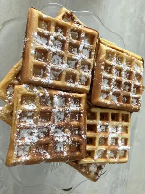 a stack of waffles sitting on top of a glass plate at Aux Belles Vacances - ADULTS ONLY in Caux-et-Sauzens