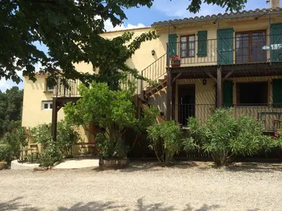 a house with a staircase in front of it at Domaine De Fraisse in Leuc