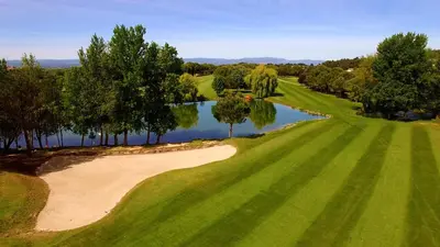 an overhead view of a golf course with a lake at Domaine De Fraisse in Leuc