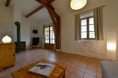 a living room with a couch and a table at Domaine De Fraisse in Leuc