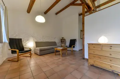 a living room with a couch and chairs and a dresser at Domaine De Fraisse in Leuc