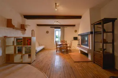 a large living room with a table and chairs at Domaine De Fraisse in Leuc