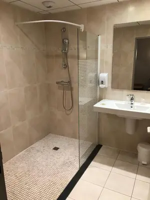a bathroom with a shower and a sink at Logis Hôtel restaurant Les Minotiers in Mirepoix
