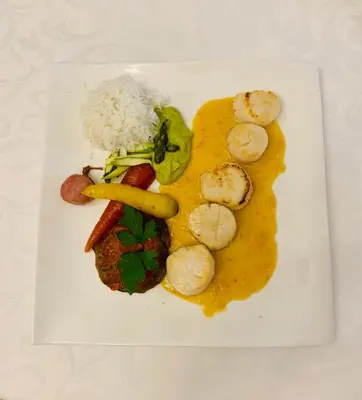 a plate of food with meat and vegetables and rice at Logis Hôtel restaurant Les Minotiers in Mirepoix