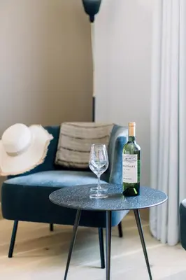 a bottle of wine and a wine glass on a table at Château L'Hospitalet Wine Resort Beach & Spa in Narbonne