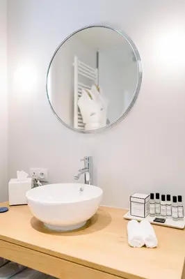 a bathroom with a sink and a mirror on a counter at Château L'Hospitalet Wine Resort Beach & Spa in Narbonne
