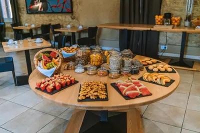 a table with many different types of food on it at Château L'Hospitalet Wine Resort Beach & Spa in Narbonne
