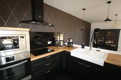 a kitchen with a sink and a microwave at La Forge in Montséret