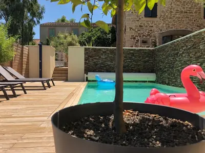 a pool with a toy flamingo and a tree at La Forge in Montséret