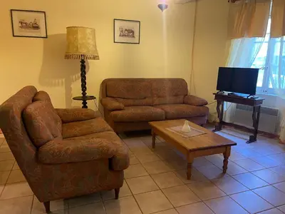 a living room with a couch and a chair and a table at Montagne d'Alaric in Moux