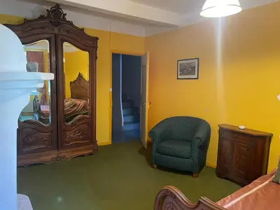 a bedroom with a chair and a large mirror at Montagne d'Alaric in Moux