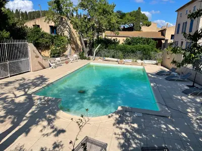 a swimming pool with blue water in a yard at Montagne d'Alaric in Moux