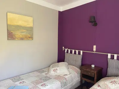 a bedroom with purple walls and a bed and a table at Montagne d'Alaric in Moux