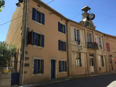an old building with a clock on top of it at Montagne d'Alaric in Moux