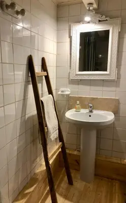 a bathroom with a sink and a mirror at Les Volets Verts in Miraval-Cabardès