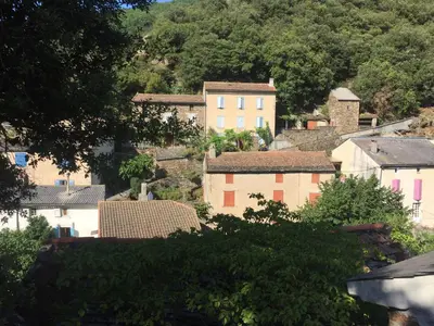 a view of a village with houses and trees at Les Volets Verts in Miraval-Cabardès