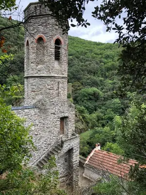 a stone tower with a window on top of a building at Les Volets Verts in Miraval-Cabardès