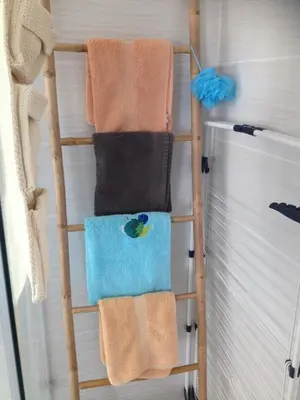 a towel rack with towels on it in a bathroom at grand studio des rivages cathares in Carcassonne