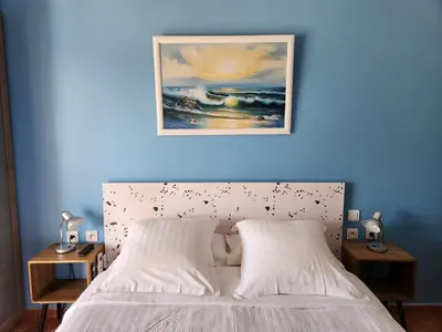a bedroom with a white bed with a blue wall at La Casa del Arti - Hôtellerie & Spa - Centre bien-être et Piscine chauffée in Sigean